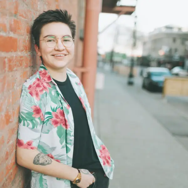 Nonbinary person smiling in Chicago, representing gender-affirming therapy and LGBTQ support.