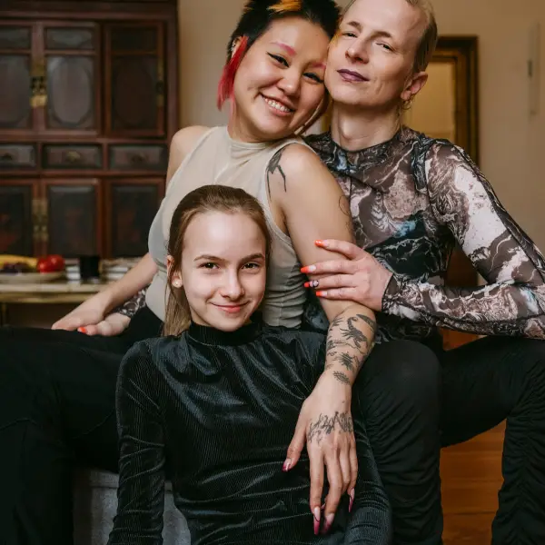 LGBTQ family smiling together, representing inclusive and affirming family therapy in Chicago.